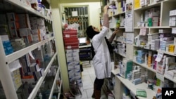 FILE - A pharmacist arranges medicine on shelves at a pharmacy in central Tehran, Iran, Dec. 11, 2012.