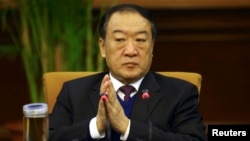 FILE - Then Communist Party Secretary of Jiangxi province, Su Rong attends a group discussion during the National People's Congress in Beijing, March 6, 2012.