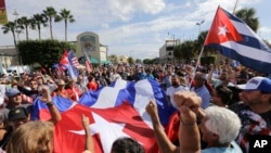 Cuban-Americans react to the death of Fidel Castro in the Little Havana area in Miami, Nov. 26, 2016. 