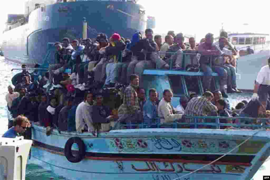 Migrants arrive at the harbor in Ragusa after a boat was intercepted by the Italian coast guard off the city of Ragusa, Italy, Tuesday, Feb. 15, 2011. Overnight, Italian authorities intercepted a boat of 32 people believed to be from Egypt off the coast o