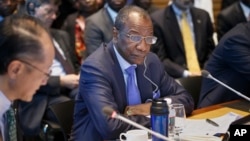 President of Guinea Alpha Conde, center, listens as the heads of the United Nations, the International Monetary Fund and the World Bank discuss the Ebola outbreak at the World Bank in Washington, Oct. 9, 2014.