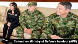 FILE - Brigadier General Ruben Alzate, right, Corporal Jorge Rodriguez, center, and lawyer Gloria Urrego were released by the FARC guerrillas in Medellin, Colombia, Nov. 30, 2014. 