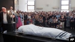 Israeli and American officials are blaming the Lebanese militant group Hezbollah for the July 18, 2012 bombing that killed five Israeli tourists, a Bulgarian bus driver and the bomber in Burgas, Bulgaria. Shown here is a funeral for one of the Israeli vic
