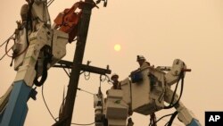 Pacific Gas & Electric crews work to restore power lines in Paradise, Calif., Nov. 9, 2018.