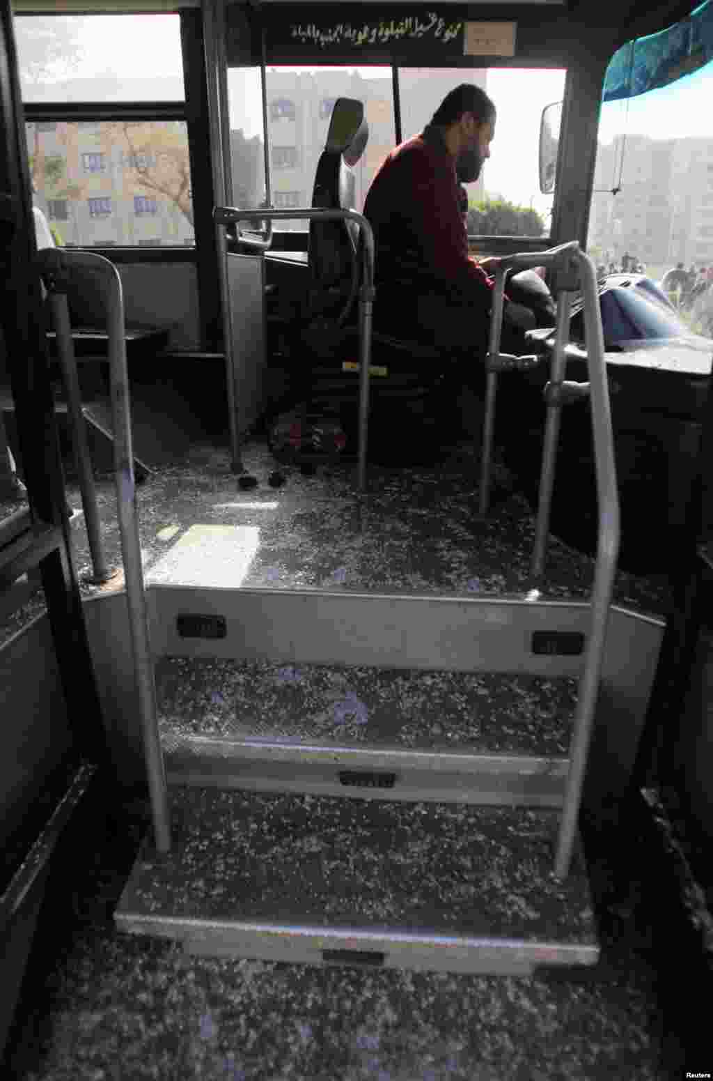 Bus driver Adel Abd El Fatah sits inside a damaged bus after a bomb blast near the Al-Azhar University campus in Cairo&#39;s Nasr City district, Dec. 26, 2013. 