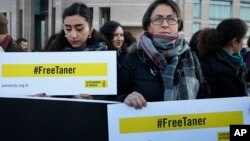 Human rights activists stage a protest demanding the release of Amnesty International's Taner Kilic, outside a court in Istanbul, Turkey, Jan. 31, 2018.