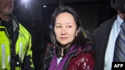 This TV image provided by CTV to AFP shows Huawei Technologies Chief Financial Officer Meng Wanzhou as she exits the court registry following the bail hearing at British Columbia Superior Courts in Vancouver, British Columbia on December 11, 2018.