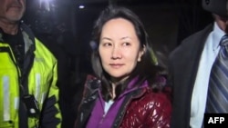 FILE - This TV image shows Huawei Technologies Chief Financial Officer Meng Wanzhou as she exits the court registry following the bail hearing at British Columbia Superior Courts in Vancouver, British Columbia, Dec. 11, 2018.