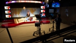 A cameraman films a news anchor at Tolo News studio in Kabul Afghanistan October 18, 2015.