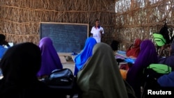 Zeinab's English teacher Abdiweli Mohammed Hersi teaches children at the school near a camp for internally displaced people from drought hit areas in Dollow, Somalia, April 3, 2017. 