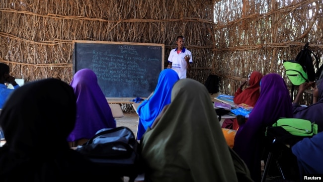 Zeinab's English teacher Abdiweli Mohammed Hersi teaches children at the school near a camp for internally displaced people from drought hit areas in Dollow, Somalia, April 3, 2017. 