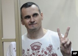 FILE - Ukrainian filmmaker Oleh Sentsov gestures as the verdict is delivered at his trial in Rostov-on-Don, Russia, Aug. 25, 2015.