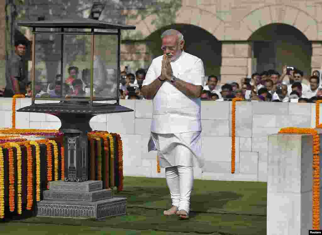 Indian Prime Minister-designate Narendra Modi walks at the Mahatma Gandhi memorial after paying the flower tribute at Rajghat, ahead of his swearing-in ceremony in New Delhi, May 26, 2014.