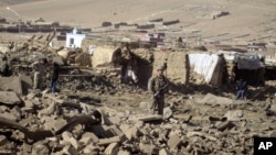 A U.S. soldier stands guard at the site of suicide attack in Wardak Province of Kabul Afghanistan, Friday, Nov, 23, 2012. 