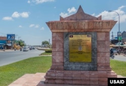 A sign in Phnom Penh from the mid 1990s, denoting USAID-funded restoration of the "Khmer-American Friendship Highway" or National Road 4 from Phnom Penh to coastal Sihanoukville, August 3, 2018. The highway remains in good condition but the United States has since not invested​ directly in other Cambodian infrastructure projects of such scale. (Courtesy of USAID)