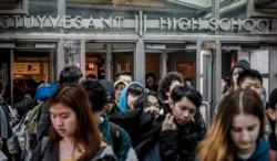 Students at Stuyvesant High School leave after classes end for the week, Friday March 13, 2020, in New York. (AP Photo/Bebeto Matthews)