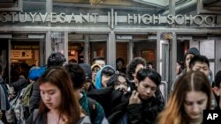 Students at Stuyvesant High School leave after classes end for the week, Friday March 13, 2020, in New York. (AP Photo/Bebeto Matthews)