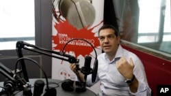 Greece's Prime Minister Alexis Tsipras gives an interview to the radio station ''Sto Kokkino 1055'' in Athens, July 29, 2015.