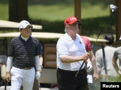 U.S. President Donald Trump and Japan's Prime Minister Shinzo Abe play golf at Mobara Country Club in Mobara, Chiba prefecture, Japan May 26, 2019, in this photo taken by Kyodo.