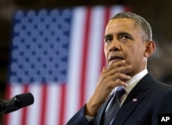 President Barack Obama pauses as he speaks at McGavock High School, Jan. 30, 2014, in Nashville, Tennessee.