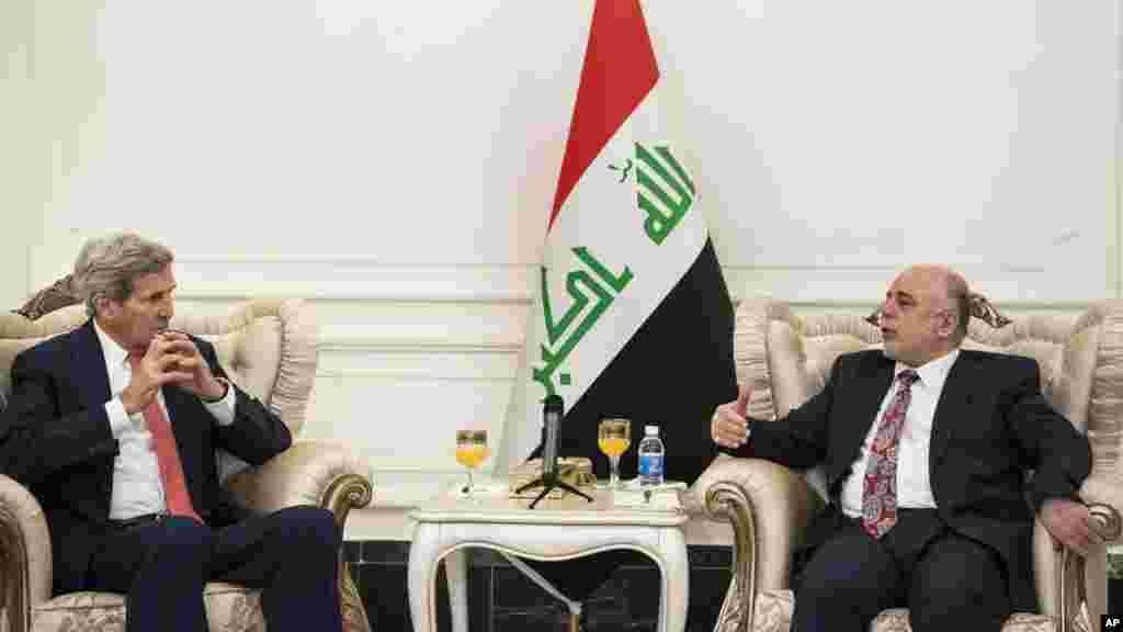 U.S. Secretary of State John Kerry, left, listens to new Iraqi Prime Minister Haider al-Abadi during a meeting in Baghdad, Iraq, Sept. 10, 2014. 