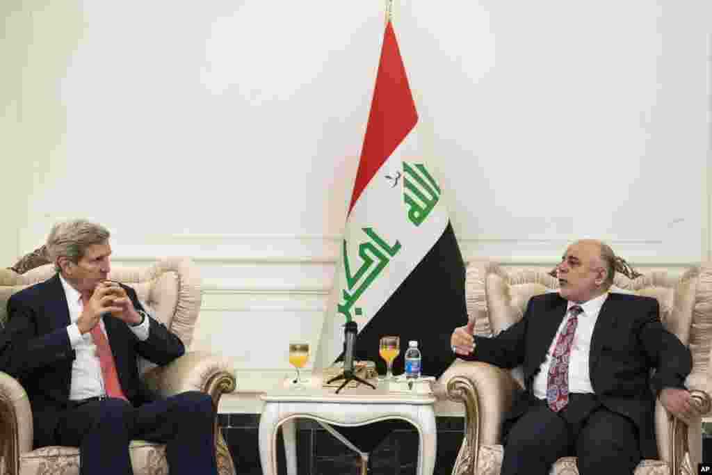 U.S. Secretary of State John Kerry, left, listens to new Iraqi Prime Minister Haider al-Abadi during a meeting in Baghdad, Iraq, Sept. 10, 2014.