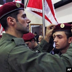 A Hezbollah fighter fixes the beret of a fellow member during a speech by Hezbollah leader Hassan Nasrallah in the southern suburb of Beirut (File)