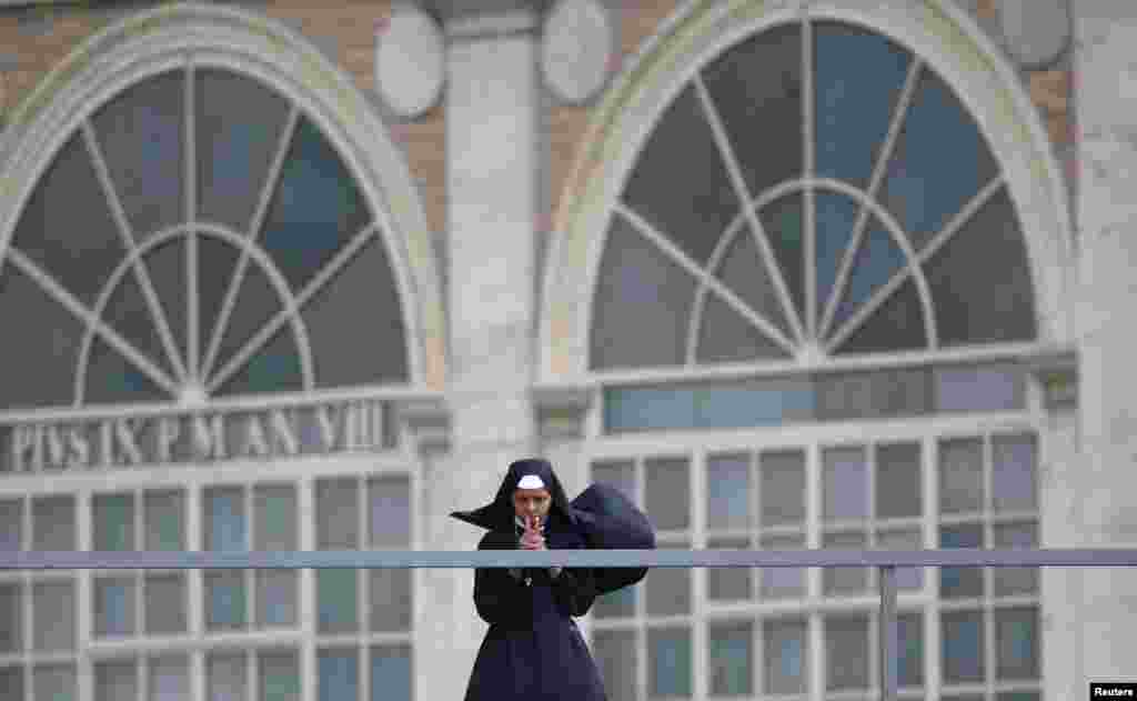 A nun prays as Pope Francis leads a canonization mass for candidates for sainthood Antonio Primaldo, Mother Laura Montoya and Maria Guadalupe Garcia Zavala, in Saint Peter's Square at the Vatican.
