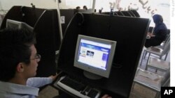 An Iranian youth browses a political blog at an internet cafe in the city of Hamadan.