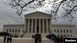 People wait in line outside the U.S. Supreme Court to hear the orders being issued, in Washington, March 18, 2019. 