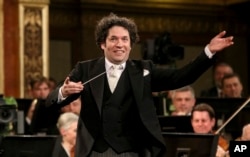 FILE - Maestro Gustavo Dudamel of Venezuela conducts the Vienna Philharmonic Orchestra during the traditional New Year's Concert at the Golden Hall of the Musikverein in Vienna, Austria, Jan. 1, 2017.