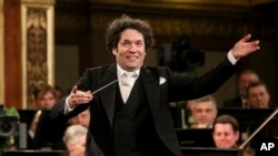 FILE - Maestro Gustavo Dudamel of Venezuela conducts the Vienna Philharmonic Orchestra during the traditional New Year's Concert at the Golden Hall of the Musikverein in Vienna, Austria, Jan. 1, 2017.