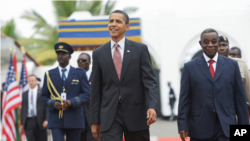 President Barack Obama walks with Ghana President John Atta Mills, right, at the Presidential Palace in Accra, Ghana, Saturday, July 11, 2009.