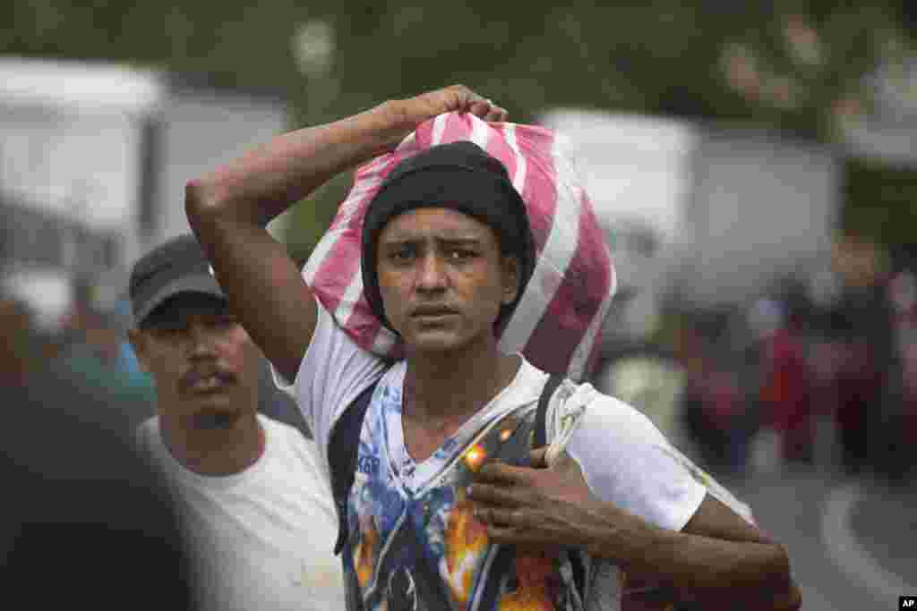 Hondurans march in a caravan of migrants moving toward the country's border with Guatemala in a desperate attempt to flee poverty and seek new lives in the United States, in Ocotepeque, Honduras, Oct. 15, 2018.