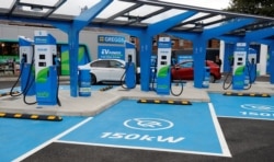 FILE - Electric vehicle charging units are pictured at newly opened MFG (Motor Fuel Group) EV Power service station in Manchester, Britain, August 31, 2021.