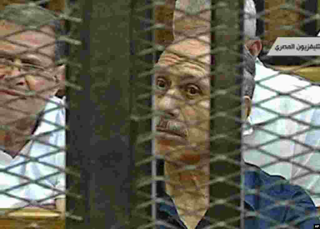 Video image taken from Egyptian State Television shows former Interior Minister Habib el-Adly, in a cage of mesh and iron bars in a Cairo courtroom. (AP Image)