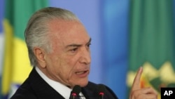 FILE - Brazil's President Michel Temer speaks during a ceremony at the Planalto Presidential Palace, in Brasilia.