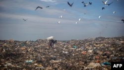 Un ramasseur d'ordures au dépôt municipal de déchets de Maputo, Mozambique, 14 octobre 2014 (AFP).