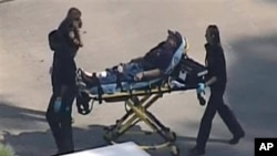 An unidentified person is transported by emergency personnel at Lone Star College in Houston, Texas Jan. 22, 2013 (Courtesy KPRC TV)