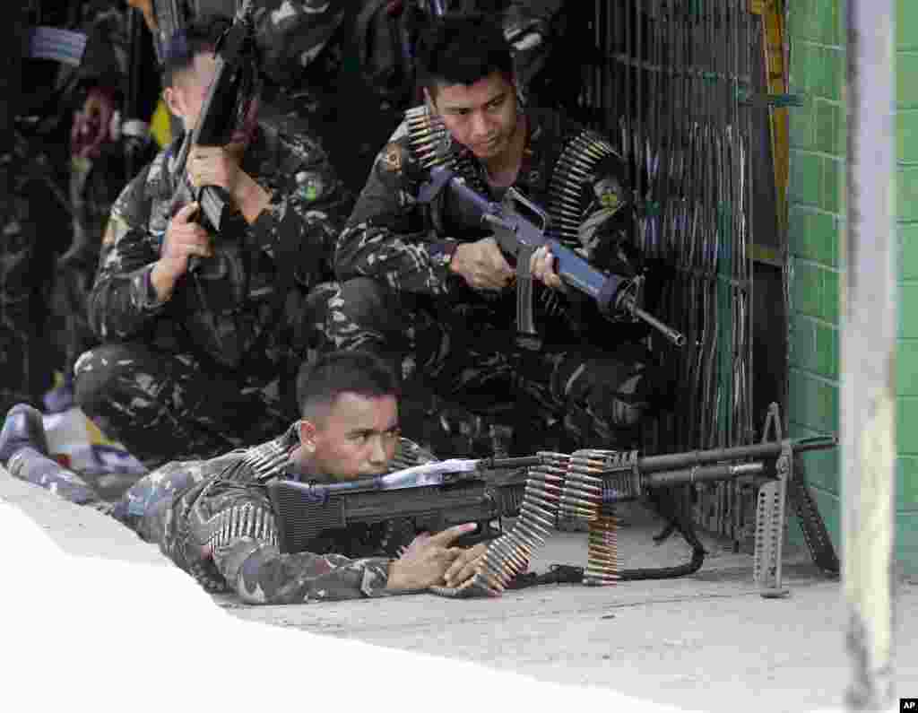 Government troopers take their positions as Muslim rebels held scores of hostages for a third day in Zamboanga, Philippines, Sept. 11, 2013