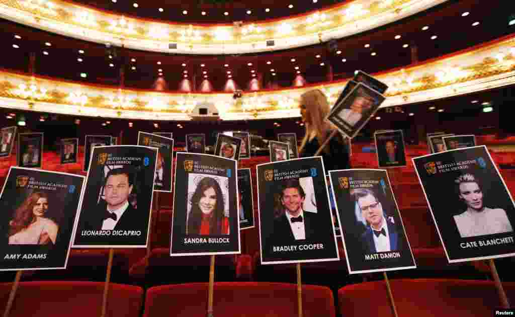 A production staff member places position markers representing guests ahead of the BAFTA awards at the Royal Opera House in central London. The BAFTA film awards will take place on Feb. 16, 2014. 