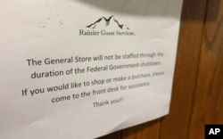A sign at the National Park Inn at Longmire at Mount Rainier National Park is displayed in Washington state and reads that the facility's general store will not be staffed due to the partial U.S. government shutdown, Dec. 22, 2018.