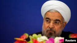 Iran's President Hassan Rouhani arrives to attend a news conference at a hotel after the fourth Conference on Interaction and Confidence Building Measures at the Asia summit, in Shanghai, May 22, 2014.