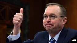 FILE - Mick Mulvaney testifies before the Senate Budget Committee on Capitol Hill in Washington, Feb. 13, 2018. 