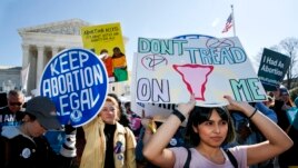 FILE - Abortion rights demonstrators including Jaylene Solache, of Dallas, Texas, right, rally, Wednesday, March 4, 2020, outside the Supreme Court in Washington. (AP Photo/Jacquelyn Martin)