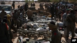 Weapons, munitions, seized from radical Islamist rebels are displayed at French army base in Gao, Mali, Feb. 24, 2013