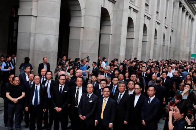 Thousands of legal professionals wearing black, stage a silent protest to the Central Government Offices, demanding authorities scrap a proposed extradition bill with China, in Hong Kong, June 6, 2019.