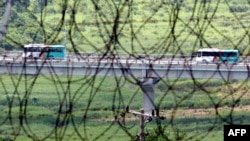 FILE - South Korean buses are seen transporting tourists near the border in Goseong, east of Seoul, from the North's Kumgang resort on July 13, 2008. 