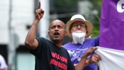 Protesters stage a rally outside the Park Hotel calling for the release of refugees being detained inside the hotel in Melbourne, Australia, Jan. 7, 2022.