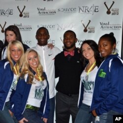 Olympic long jump hopeful Norris Frederick (in white jacket) poses with "celebrity dates" at a fundraising auction in Seattle.